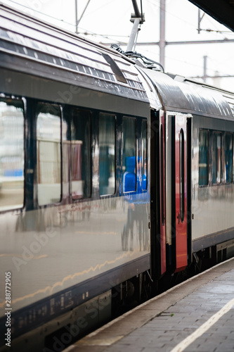 Train with open doors on railway station platform in Oostende railway station on Natienkaai 1