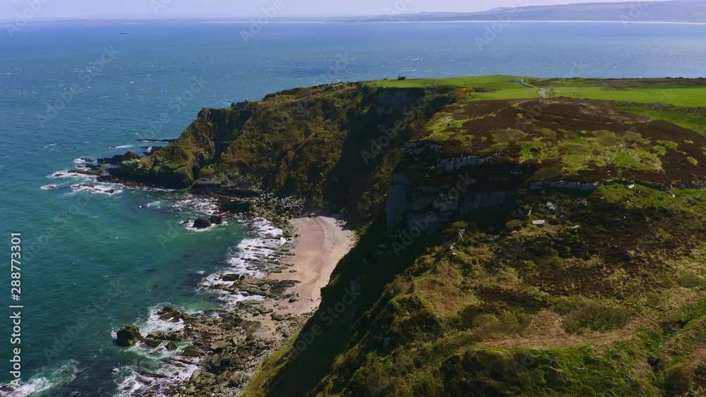 Aerial of people enjoying the view from the top of a cliff in Ireland coastline Aerial of people enjoying the view from the top of a cliff in Ireland coastline