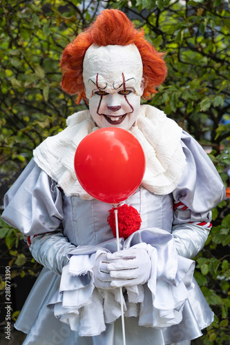 Creepy clown with red balloon