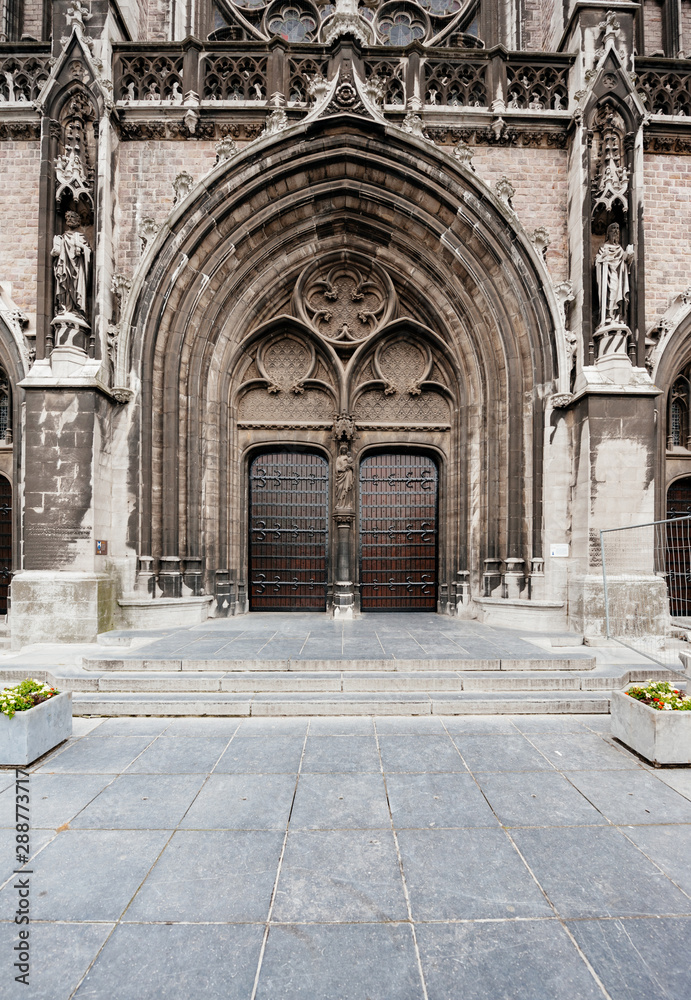 Large main central wooden door to Neo-Gothic Sint-Petrus-en-Pauluskerk the main church of Ostend, Belgium a Roman Catholic church