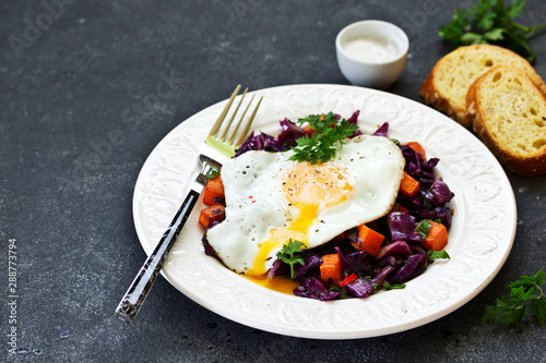 Fried eggs with warm salad of red cabbage and pumpkin.