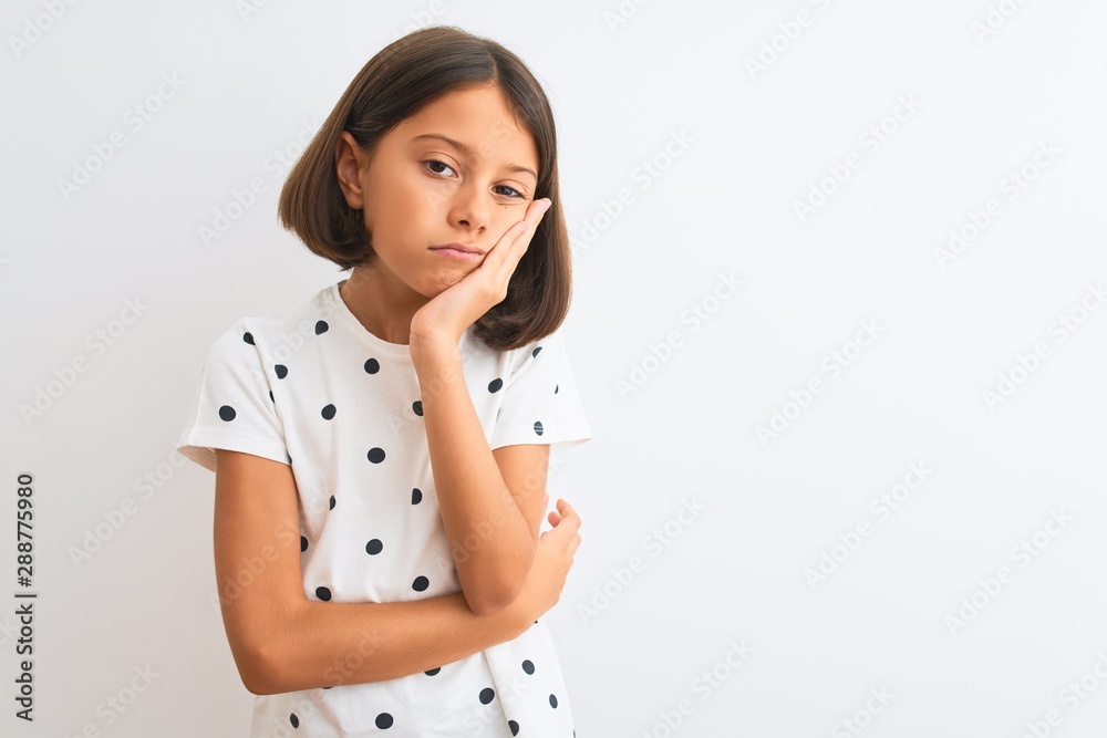 Young beautiful child girl wearing casual t-shirt standing over isolated white background thinking looking tired and bored with depression problems with crossed arms. Young beautiful child girl wearing casual t-shirt standing over isolated white background thinking looking tired and bored with depression problems with crossed arms.