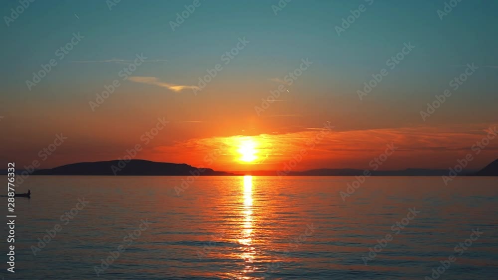 Colorful sunset above the sea. Old and modern boat floats on the sea. Magical summer sunset Colorful sunset above the sea. Old and modern boat floats on the sea. Magical summer sunset