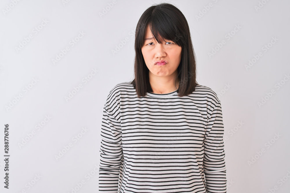 Young beautiful chinese woman wearing black striped t-shirt over isolated white background depressed and worry for distress, crying angry and afraid. Sad expression. Young beautiful chinese woman wearing black striped t-shirt over isolated white background depressed and worry for distress, crying angry and afraid. Sad expression.