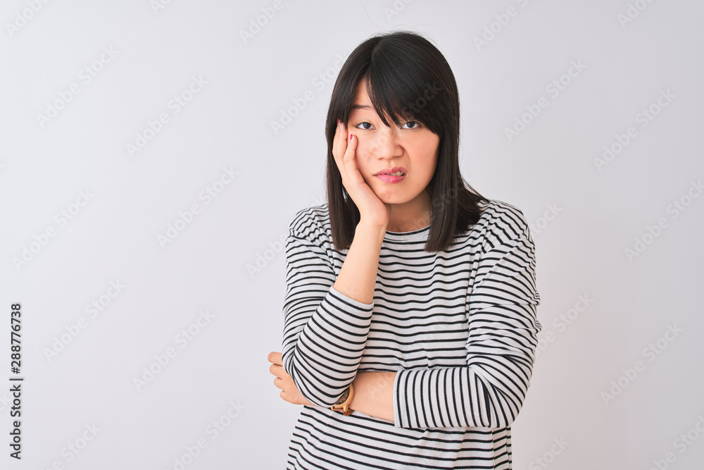 Young beautiful chinese woman wearing black striped t-shirt over isolated white background thinking looking tired and bored with depression problems with crossed arms. Young beautiful chinese woman wearing black striped t-shirt over isolated white background thinking looking tired and bored with depression problems with crossed arms.