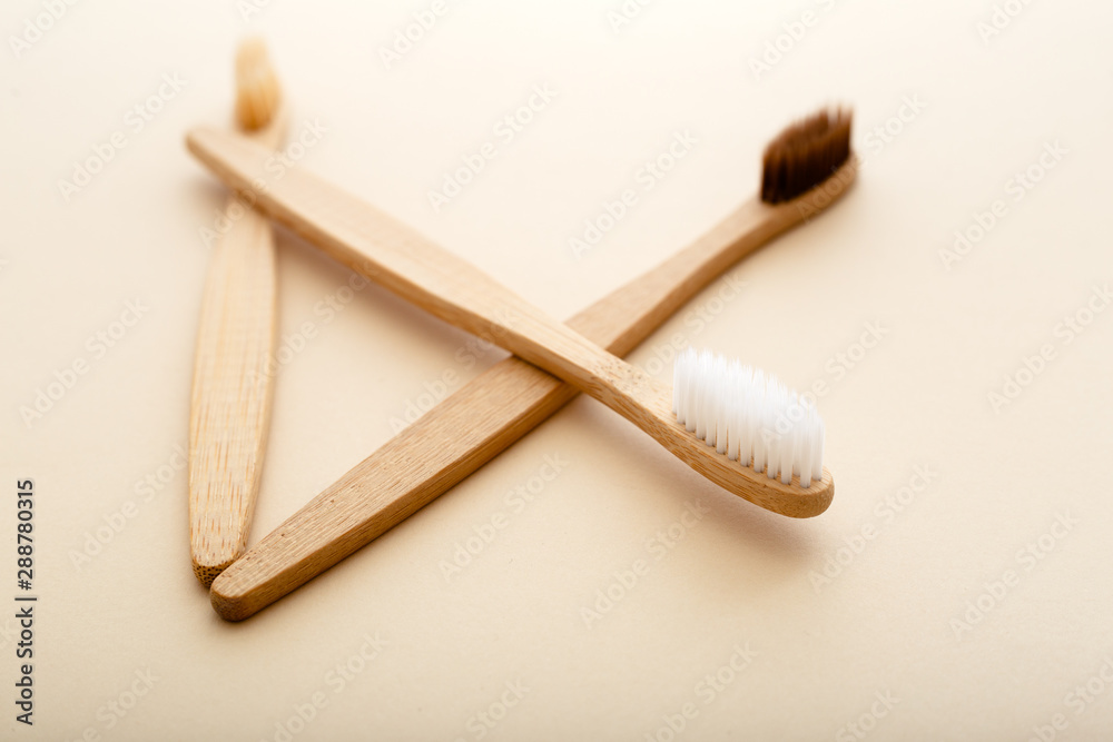 Eco-friendly bamboo tooth brush. Zero waste set on light beige natural background. Flat lay style. Eco-friendly bamboo tooth brush. Zero waste set on light beige natural background. Flat lay style.