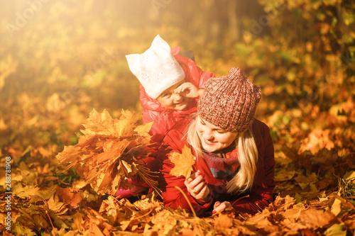 Mother and daughter in a autumn park