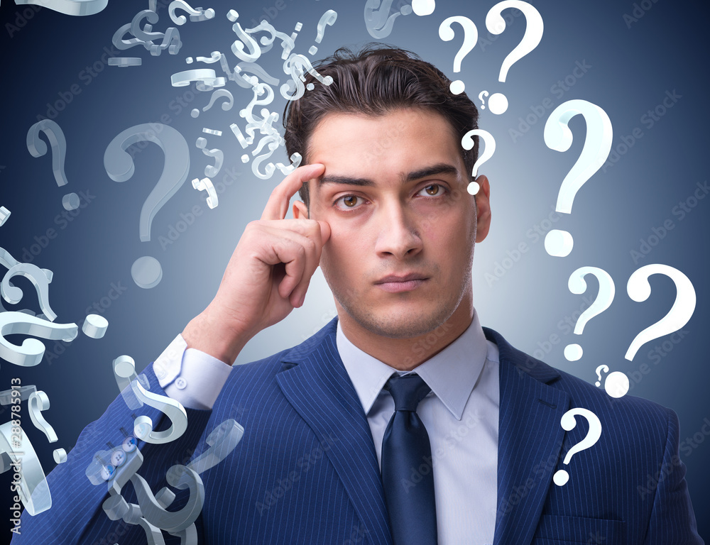 Businessman in uncertainty concept with many unanswered question Businessman in uncertainty concept with many unanswered question