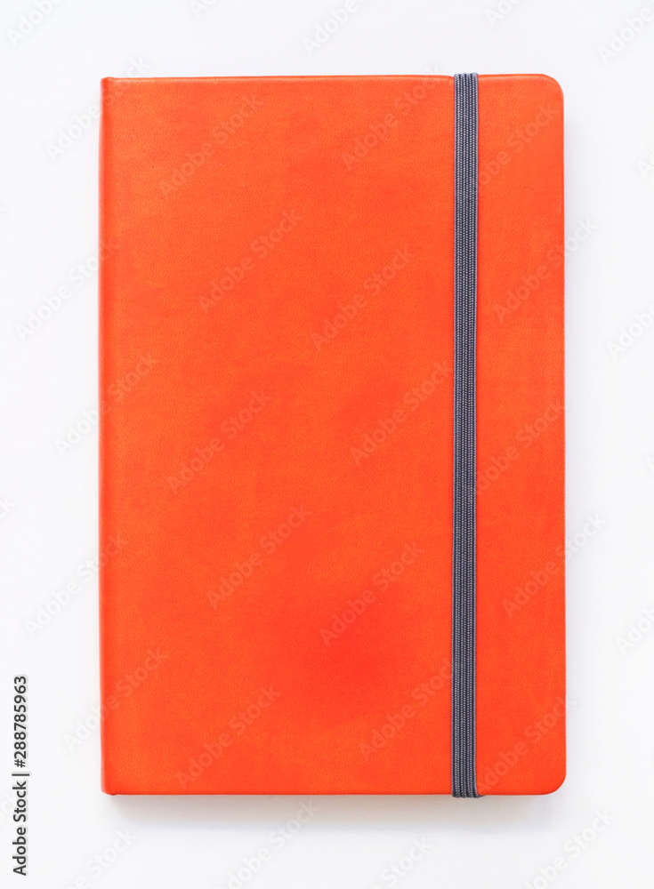 Orange closed notebook mockup isolated on white Orange closed notebook mockup isolated on white