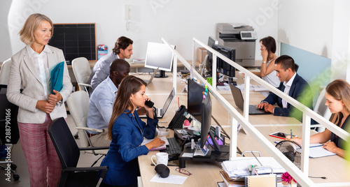 Multiracial group of successful business people during daily work in modern co-working space