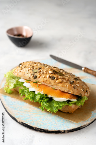 Healthy sandwich with salmon on white background