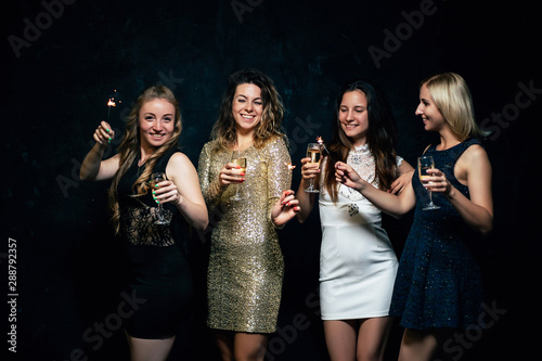 Girls party. Closeup of glasses with champagne. Young ladies celebrating, having fun together. Women night out concept, hen party