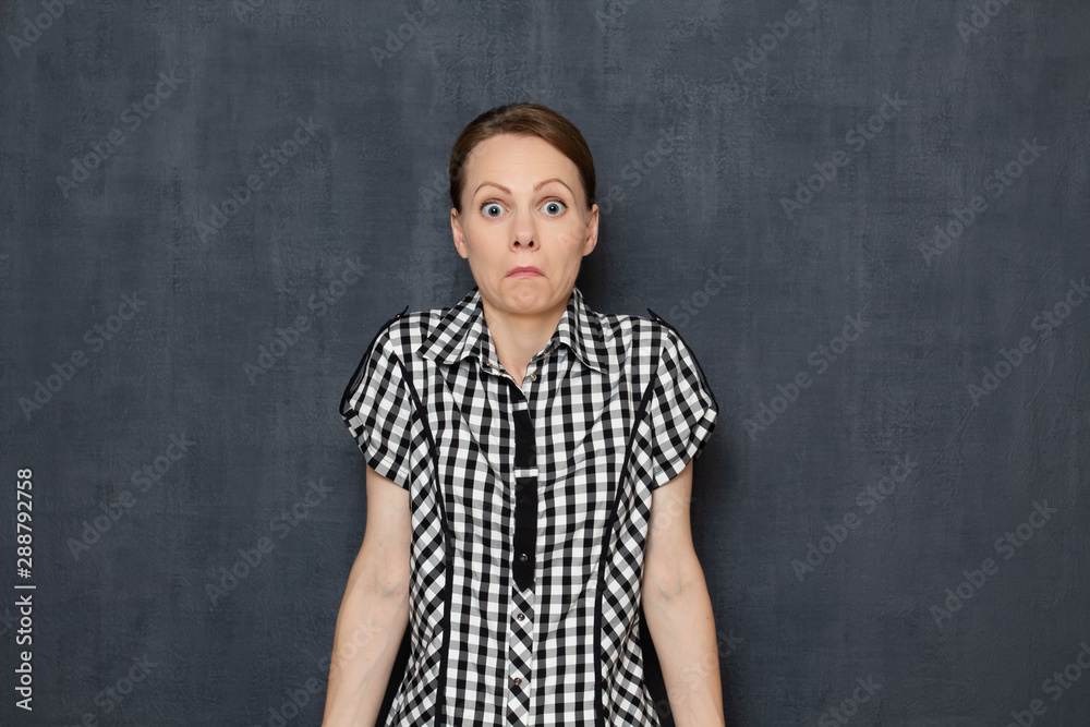 Portrait of perplexed woman shrugging shoulders being shocked