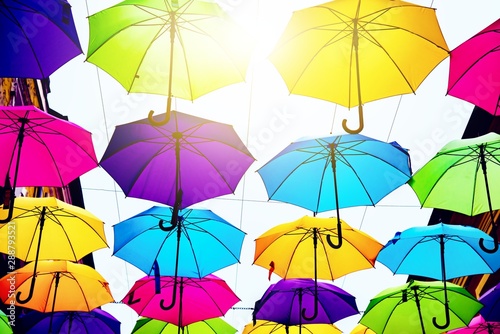 Fototapeta Naklejka Na Ścianę i Meble -  Umbrellas in the air . bright small streets of the city