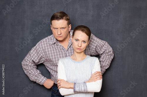 Portrait of serious and dissatisfied caucasian man and woman