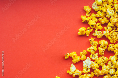 Popcorn on a red background with space for text