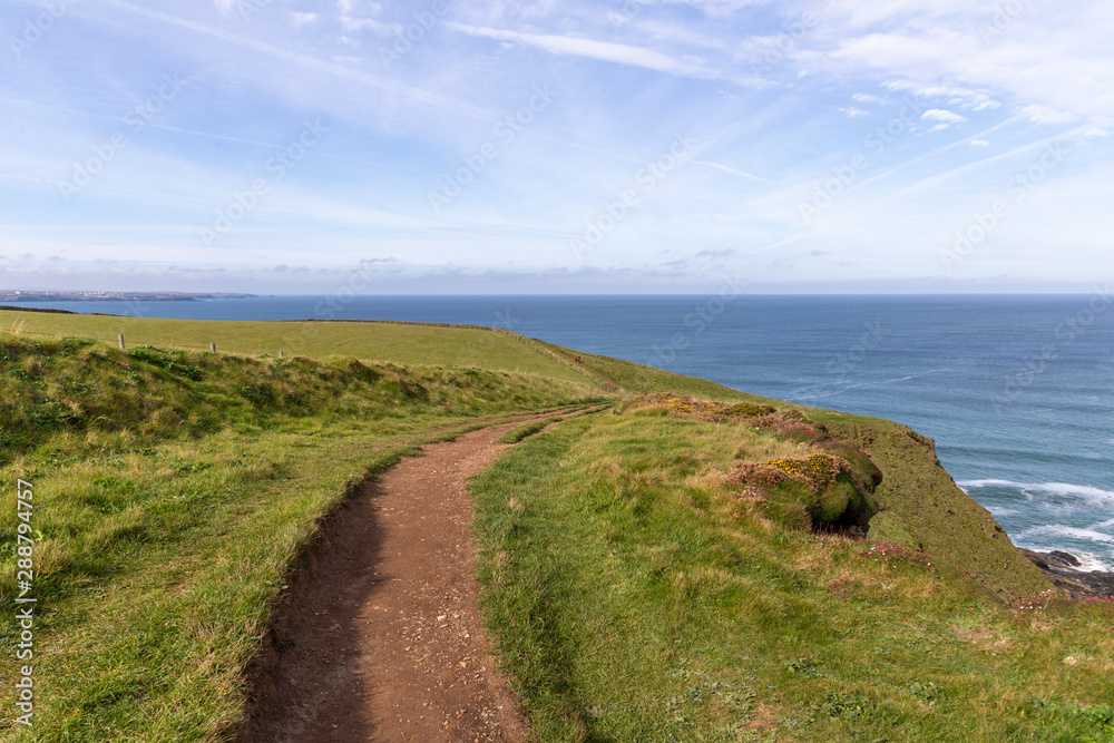 A landscape view of Mawgan Porth from the South West Coast Path, North Cornwall along the Atlantic coast near Newquay