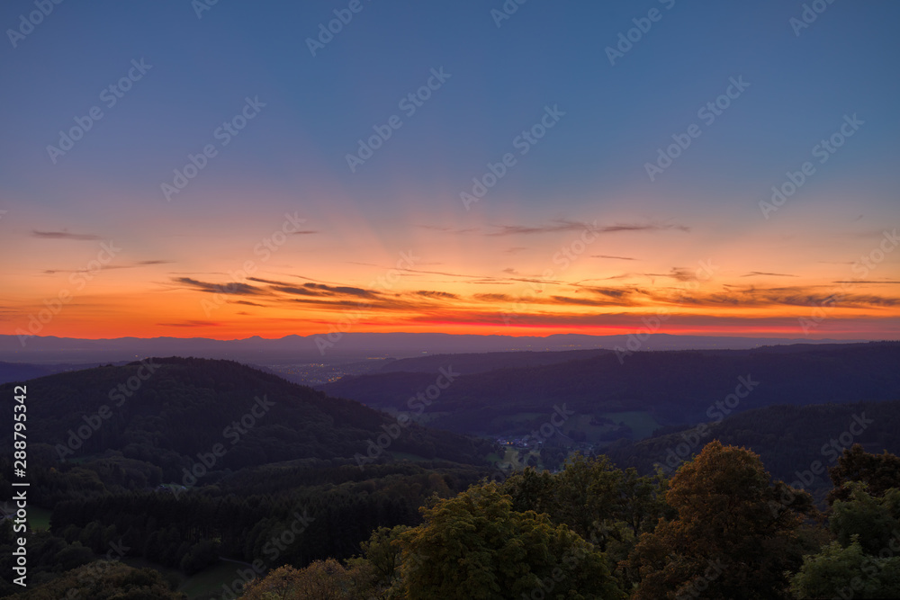 View over some Black Forest hills from the castle Hohengeroldseck on the evening sunset