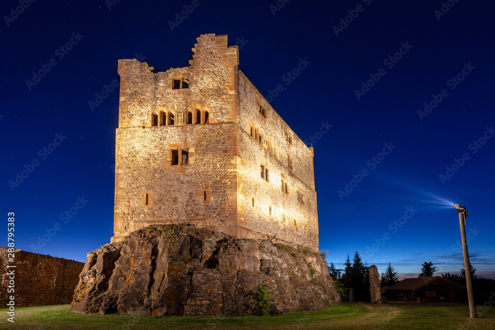 Nocturnal view of the castle Hohengeroldseck in the Black Forest which is illuminated by strong spotlights
