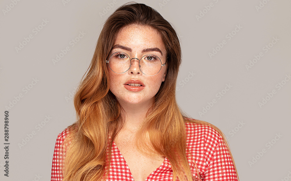 Ginger girl with freckles posing in studio, emotions. Ginger girl with freckles posing in studio, emotions.