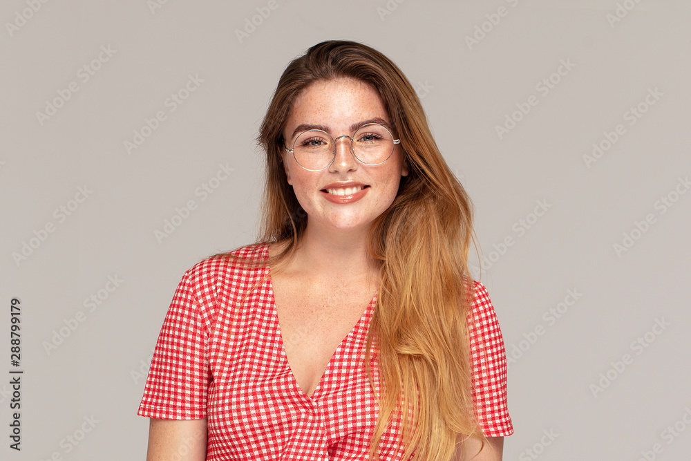Ginger girl with freckles posing in studio, emotions. Ginger girl with freckles posing in studio, emotions.
