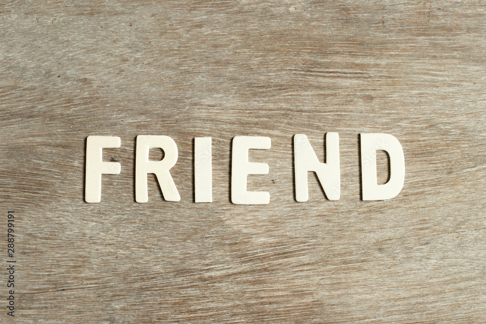 Fototapeta premium Alphabet letter in word firend on wood background