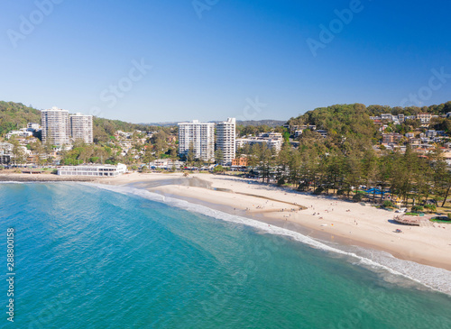  Burleigh heads on the gold coast with nice afternoon sun, gentle waves and beach lifestyle. Aerial view of a favourite holiday destination in Queensland, Australia