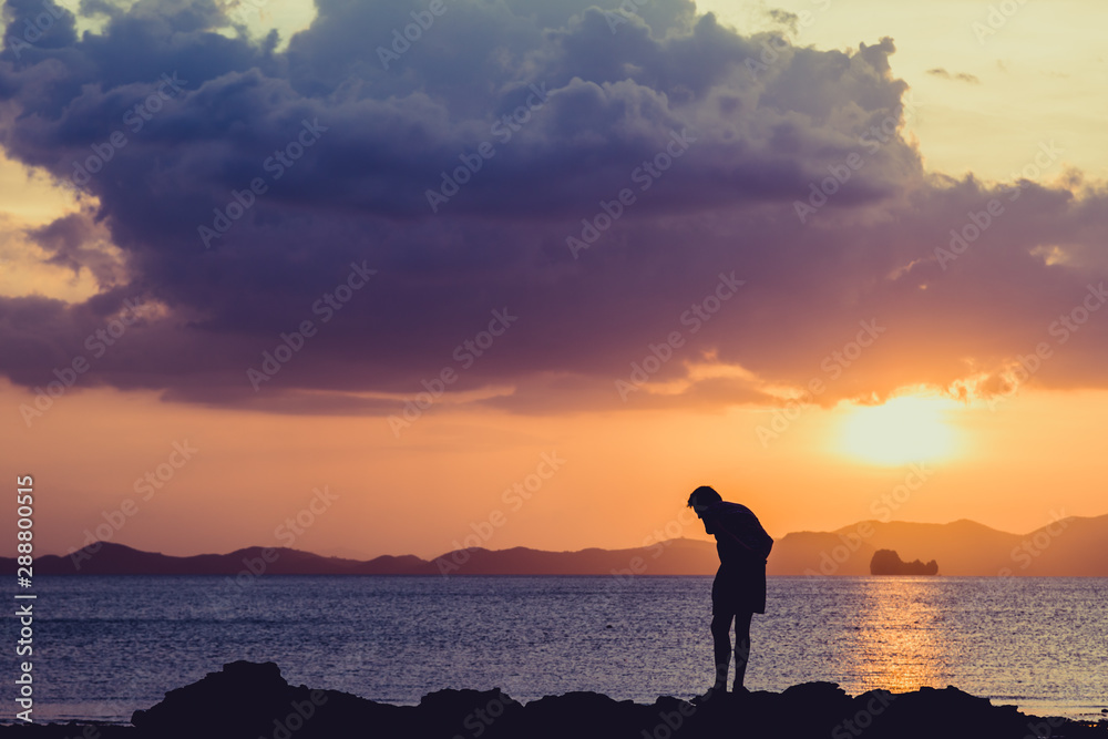 Siluate lonely man at the beach before sunset Siluate lonely man at the beach before sunset