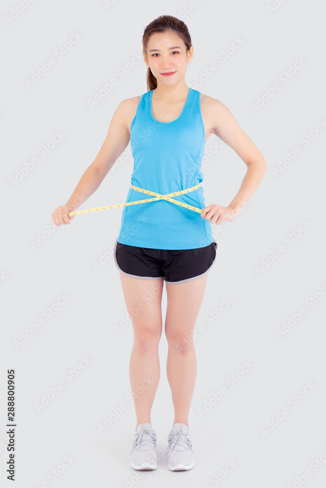 Beautiful slim young asian woman measuring tape thin waist wear uniform fitness isolated white background, asia girl loss weight for diet with exercise and workout wellbeing and healthy care body. Beautiful slim young asian woman measuring tape thin waist wear uniform fitness isolated white background, asia girl loss weight for diet with exercise and workout wellbeing and healthy care body.
