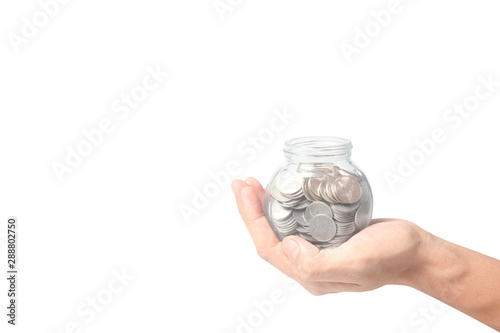 Human hands holding coins in the glass