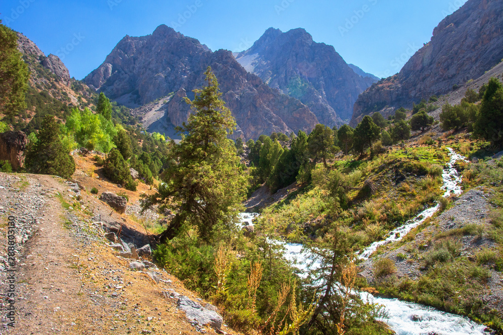 Scenic mountain landscape with river on clear summer day. Beautiful bright mountains. Hiking in mountains. Amazing mountain nature