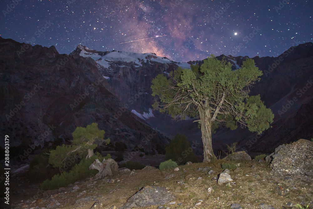 Night scene in Fann mountains, Pamir, Alay, Tajikistan. Night mountain landscape with starry sky and Milky Way