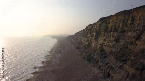 4K Drone shot of Hengistbury Head cliffs facing back towards Bournemouth. This shot was taken as the sun was going down. photo