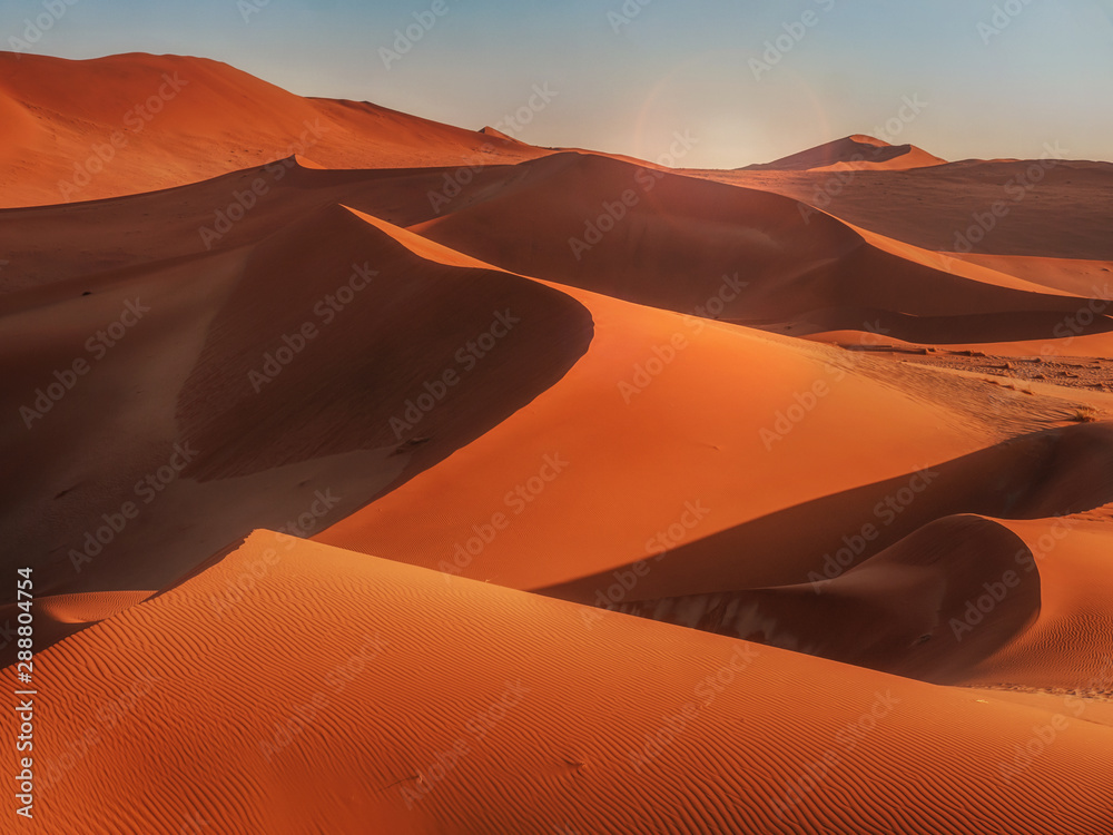 Sun rising over the red sand dunes of the Namib Desert, Namibia. Stock  Photo