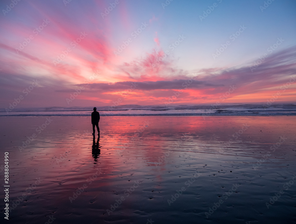 Colorful Sky at Sunset, Reflecting on Wet Sand Pacific Ocean, One Person in Silhouette