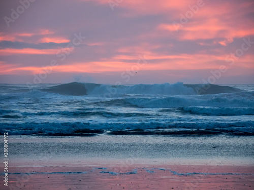 Colorful Sunset over Pacific Ocean, Crashing Waves and Pink Sky