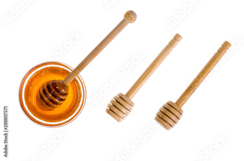Wooden spoons for honey isolated on white background.