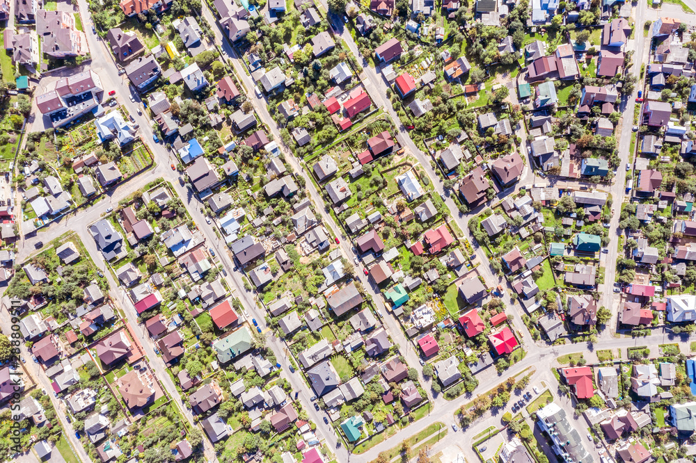 aerial top view of a suburb residential area with houses and gardens aerial top view of a suburb residential area with houses and gardens