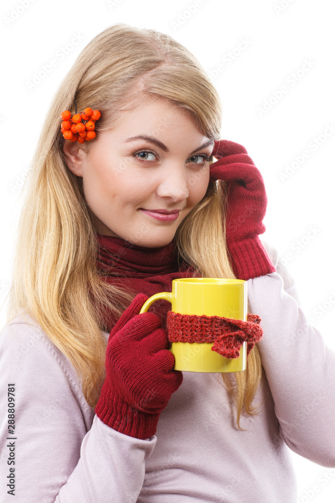 Happy smiling girl in woolen gloves holding cup of tea wrapped scarf Happy smiling girl in woolen gloves holding cup of tea wrapped scarf