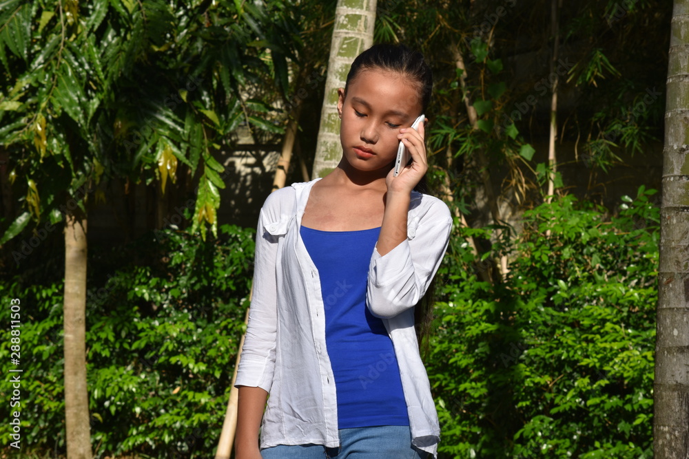 Filipina Teenager Girl Using Cell Phone And Unhappy