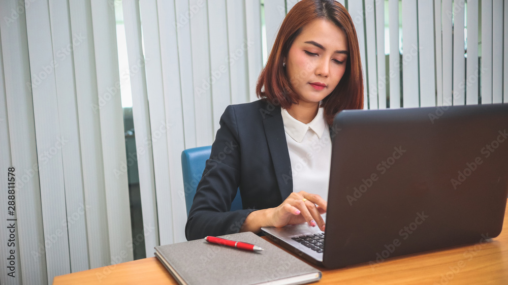 Business woman working in office with laptop Business woman working in office with laptop