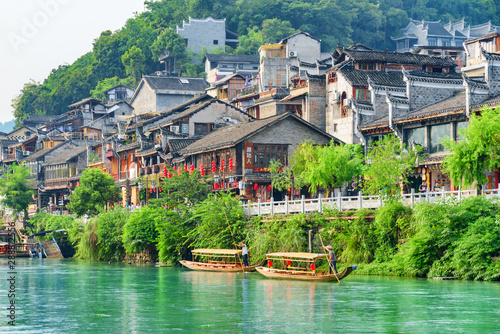 View of traditional wooden tourist boats on the Tuojiang River photo