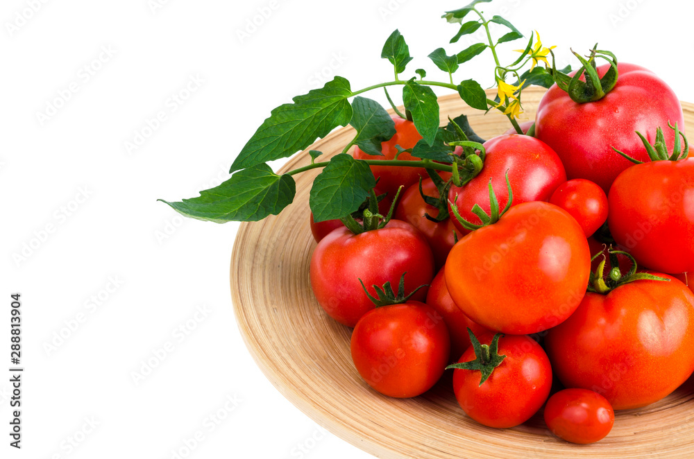 Wooden dish with different ripe tomatoes on white background. Wooden dish with different ripe tomatoes on white background.