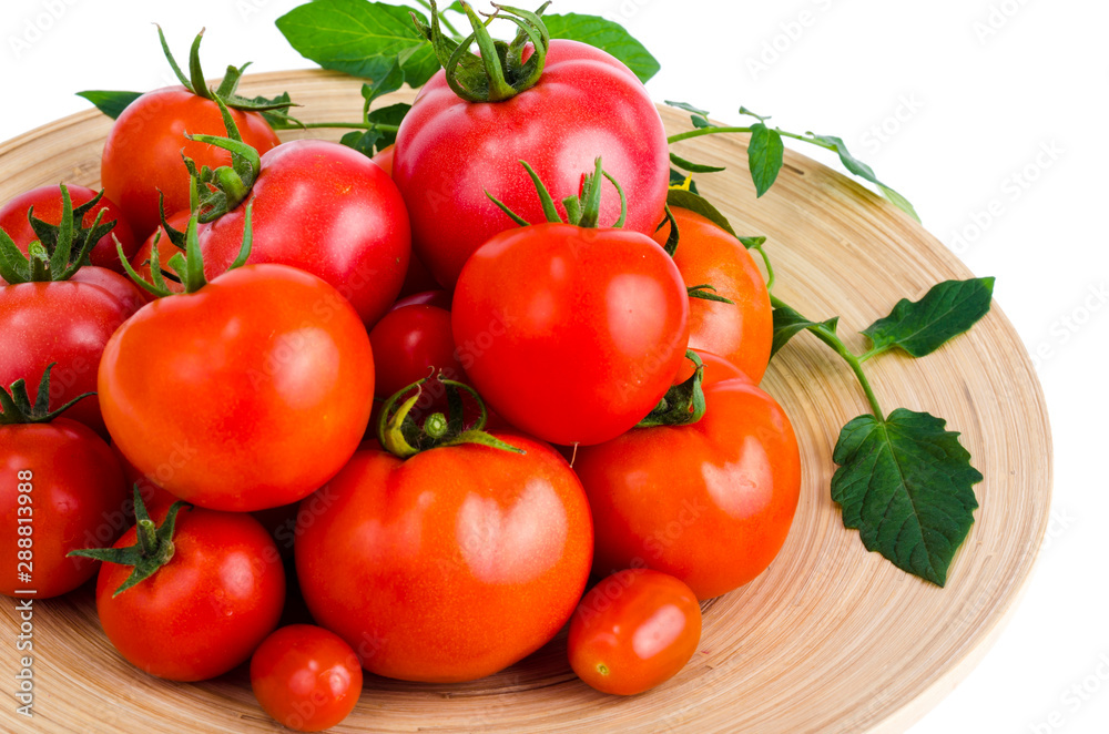 Wooden dish with different ripe tomatoes on white background. Wooden dish with different ripe tomatoes on white background.