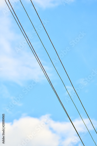 Power lines against a clear blue sky. Top down view