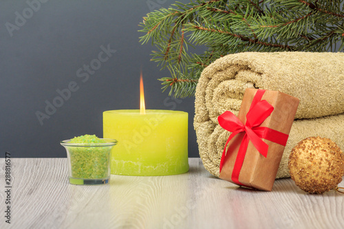 Spa composition with towel, sea salt and burning candle