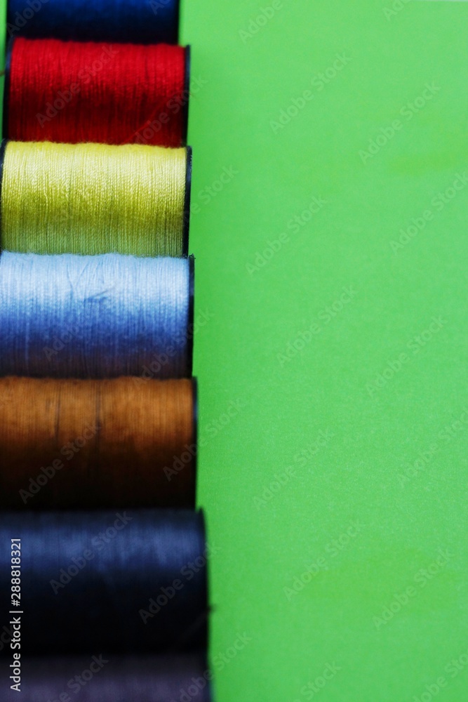 threads and needles on the background with patterns, accessories for cutting and sewing, womens hobby, tailoring threads and needles on the background with patterns, accessories for cutting and sewing, womens hobby, tailoring