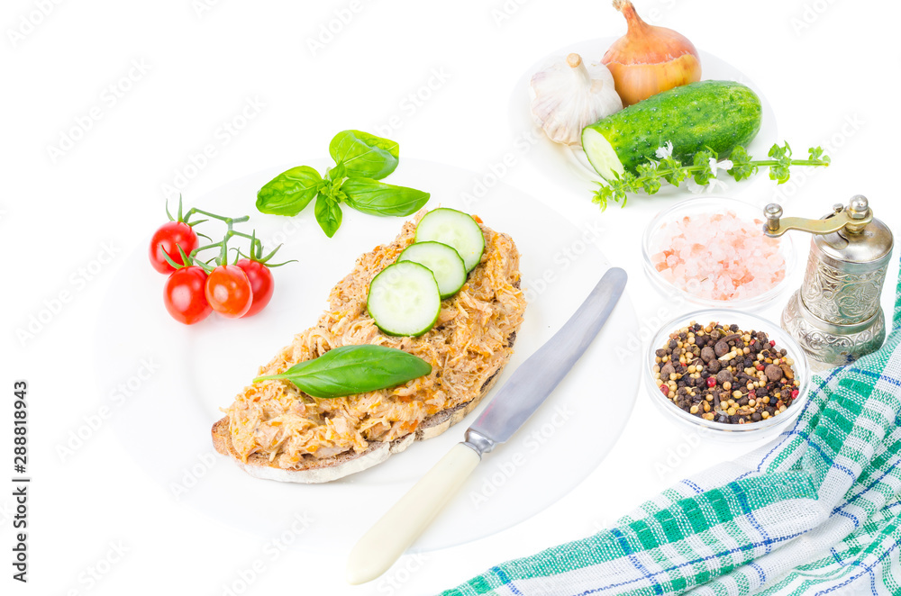 Bread slice with chicken rillettes close up on white plate. Bread slice with chicken rillettes close up on white plate.