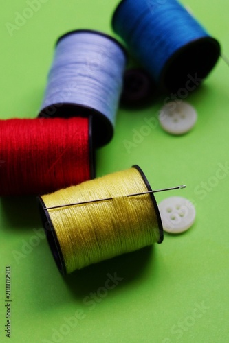 threads and needles on the background with patterns, accessories for cutting and sewing, womens hobby, tailoring