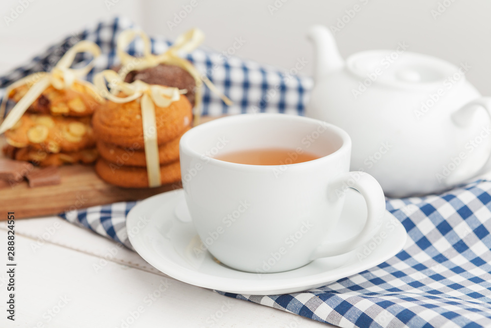 Homemade crunchy cookies and tea on a wooden table Homemade crunchy cookies and tea on a wooden table